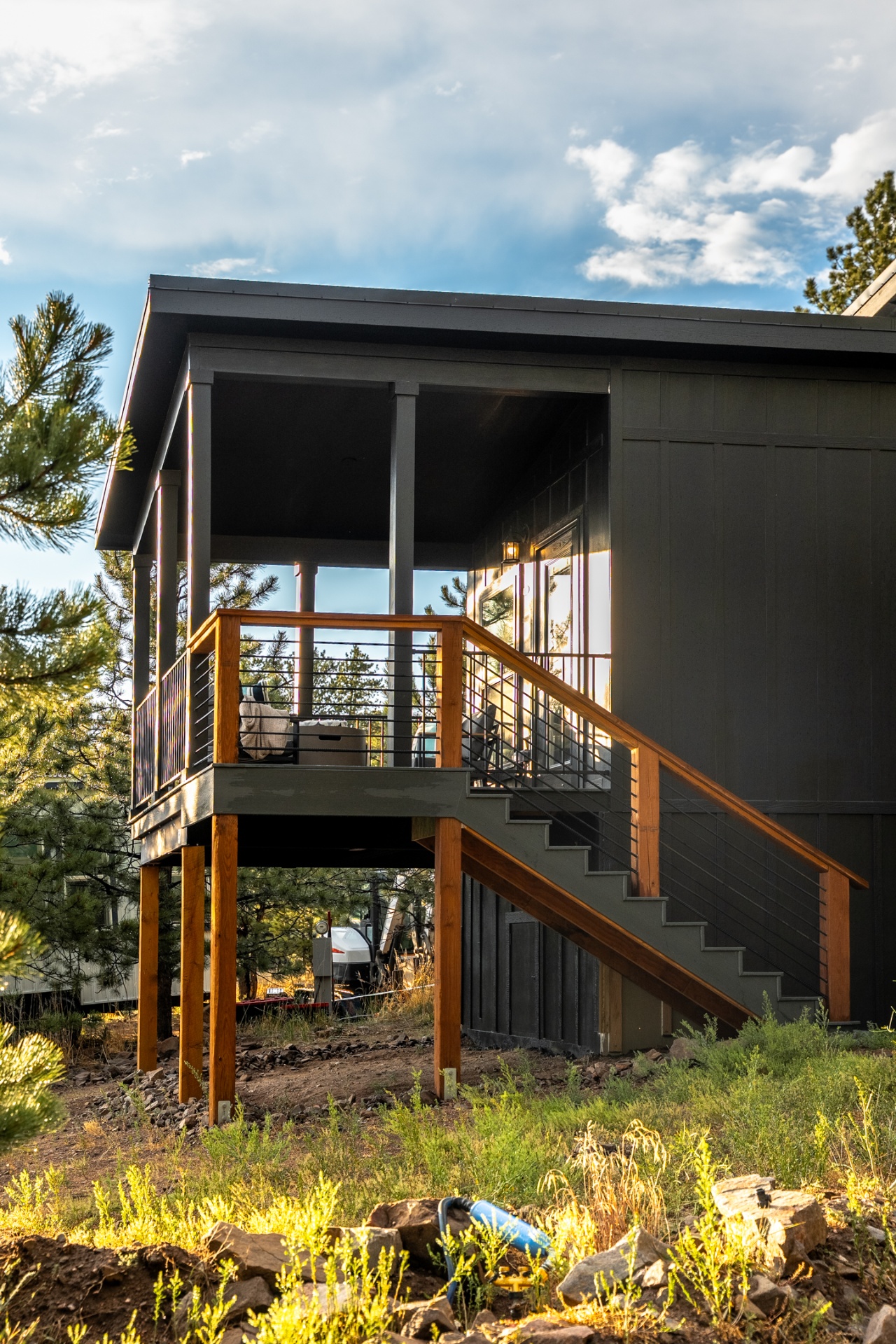 Side view of La Casa Noche showing the elevated covered deck and stairs