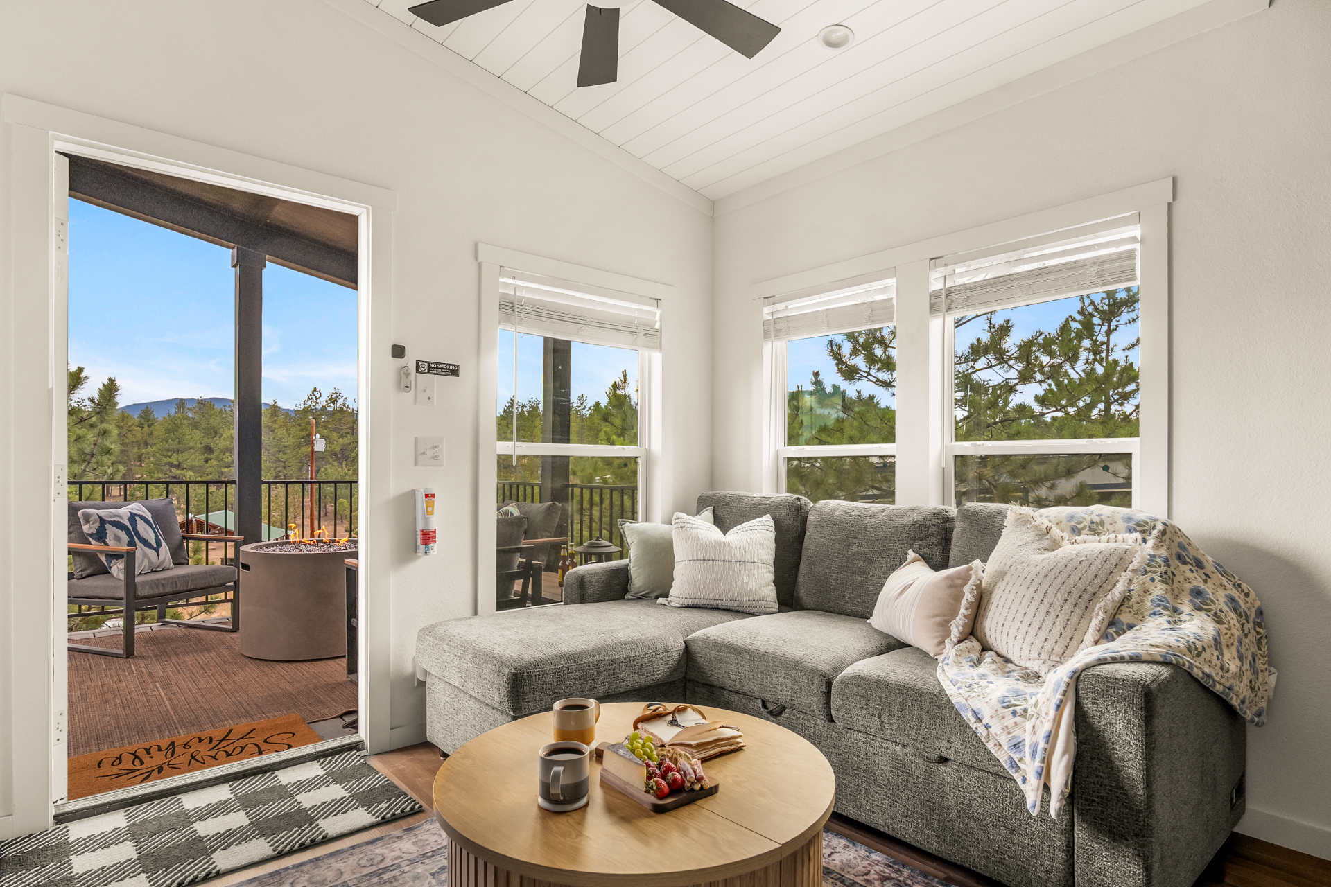 Sunlit living room with soft linens and mountain views