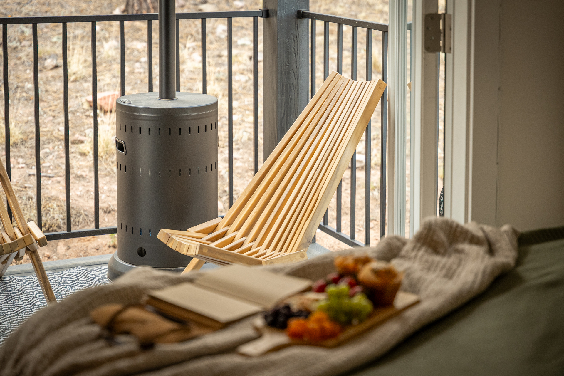 Wooden deck chair and patio heater overlooking the forest